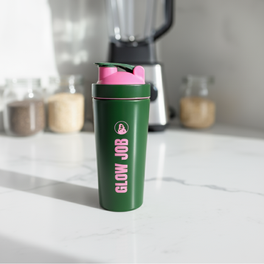 Green shaker bottle with pink top on a kitchen counter